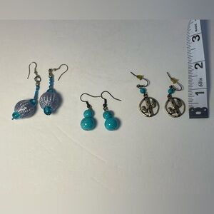 Three pairs of drop earrings with cut out gold cactus and turquoise colors.
